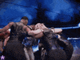 a group of people are huddled together in a circle