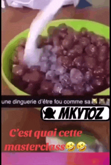 a green bowl of beans with a spoon in it and a caption that says " mkytoz "