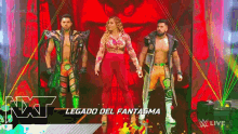 a group of wrestlers are standing next to each other in front of a red background .