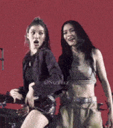 two women are dancing on a stage with the name sxrinn.z on the bottom left