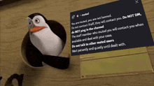 a penguin is standing next to a note that says muted