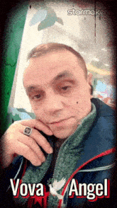 a man wearing a ring with the name vova angel written on it