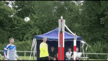 a man in a yellow shirt with the number 7 on it is playing soccer