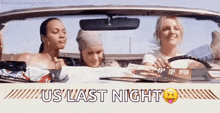 three women are sitting in a car with the words `` us last night '' written on the side .