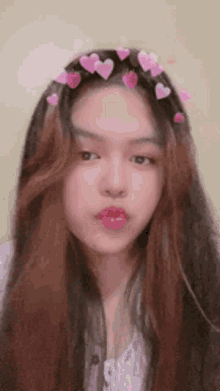 a girl with long hair and hearts on her head
