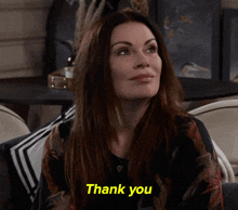 a woman sitting on a couch with her eyes closed says thank you