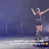 a woman is dancing on a stage with the caption she does n't got a single song