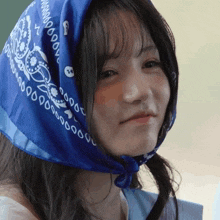 a woman wearing a blue bandana that says ' 000000 ' on it