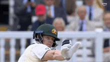 a cricket player wearing a helmet and batting gloves with the word prime in the corner