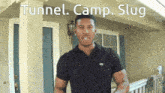 a man standing in front of a house with tunnel camp slug written on the top