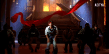 a group of people are dancing in a dark room with the word aditya on the bottom