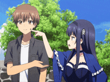 a boy and a girl are standing next to each other and the girl has an x on her hair