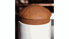 a close up of a chocolate souffle in a white bowl .