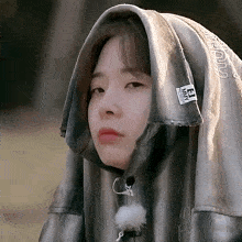 a woman wearing a hooded jacket with a label on it that says ' nmv '