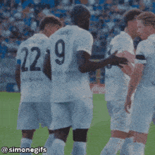 a group of soccer players on a field with the number 19 on their back