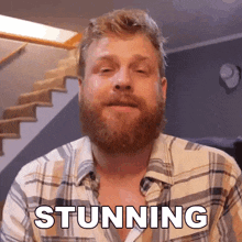 a man in a plaid shirt says stunning