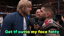a man holding a microphone with the words get tf outta my face fatty above him