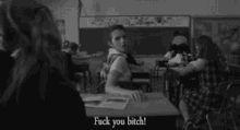 a black and white photo of a classroom with the words fuck you bitch