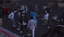 a group of people are standing in a circle on the street