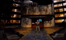 a man is standing on a stage with a microphone in his hand and a sign that says ' the lightning ' on it