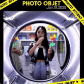 a woman is taking a picture of herself in a washing machine with the date january 19 2025