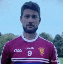 a man with a beard wearing a purple jersey with the number 9 on it