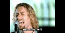 a man singing into a microphone with the words " someday i will " below him
