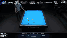 a pool table with a blue cloth and a diamond logo on it