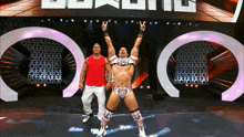 a man in a red shirt is standing next to a man in a white shirt and a man in a white pants