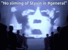 a group of people looking at a screen that says ' no sliming of styxin in #general ' on it