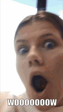 a woman with a surprised look on her face and the words w000000w written below her