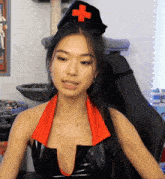 a woman wearing a nurse costume with a red cross on her hat