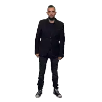 a man with a beard is wearing a black suit and jeans