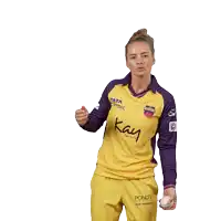 a woman is wearing a yellow and purple shirt that says kay beauty