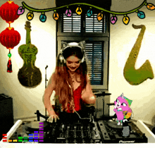 a woman wearing headphones is playing music on a pioneer turntable