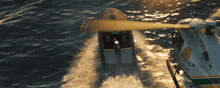 a police helicopter is flying over a speed boat in the ocean