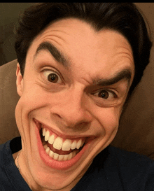 a close up of a man 's face making a funny face