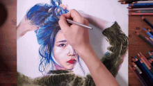 a person drawing a woman with blue hair