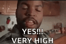 a man with a beard is making a face and saying `` yes ! '' very high .