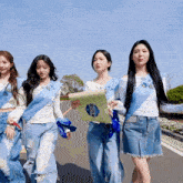 a group of girls are walking down a street wearing sashes that say miss universe