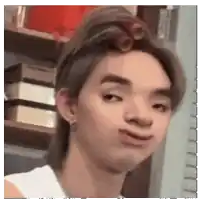 a man with curlers in his hair making a funny face .