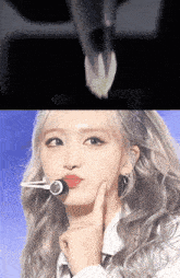 a close up of a woman 's face with a microphone on her mouth