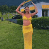a woman in a yellow dress is standing in front of a mcdonald 's