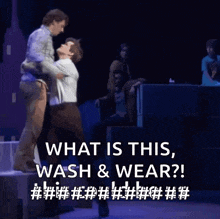two men hugging on a stage with the words " what is this wash and wear "