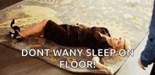 a woman in a black dress is laying on a rug with the words `` do n't wan y sleep on floor ! ''