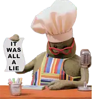 a stuffed animal wearing a chef 's hat and apron holds up a sign that says it was all a lie