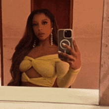 a woman is taking a picture of herself in a mirror