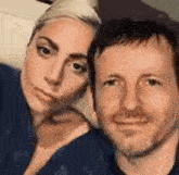 a man and a woman are posing for a picture together and smiling .