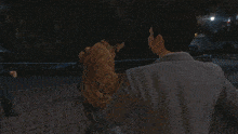 a man in a yellow jacket is being attacked by another man