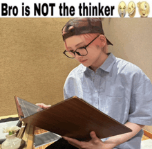 a person wearing glasses and a baseball cap is reading a book with the words bro is not the thinker above them